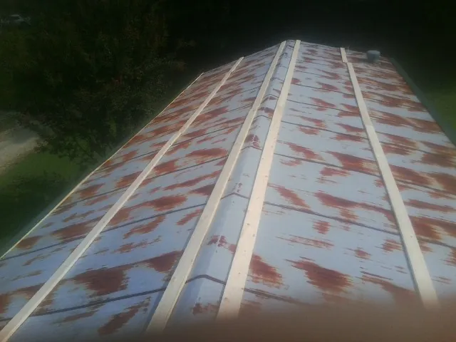 Rusted metal roof panels with new wood purlins before replacement — Storm Damage Roof Repair in Moonachie by Roofing Brothers