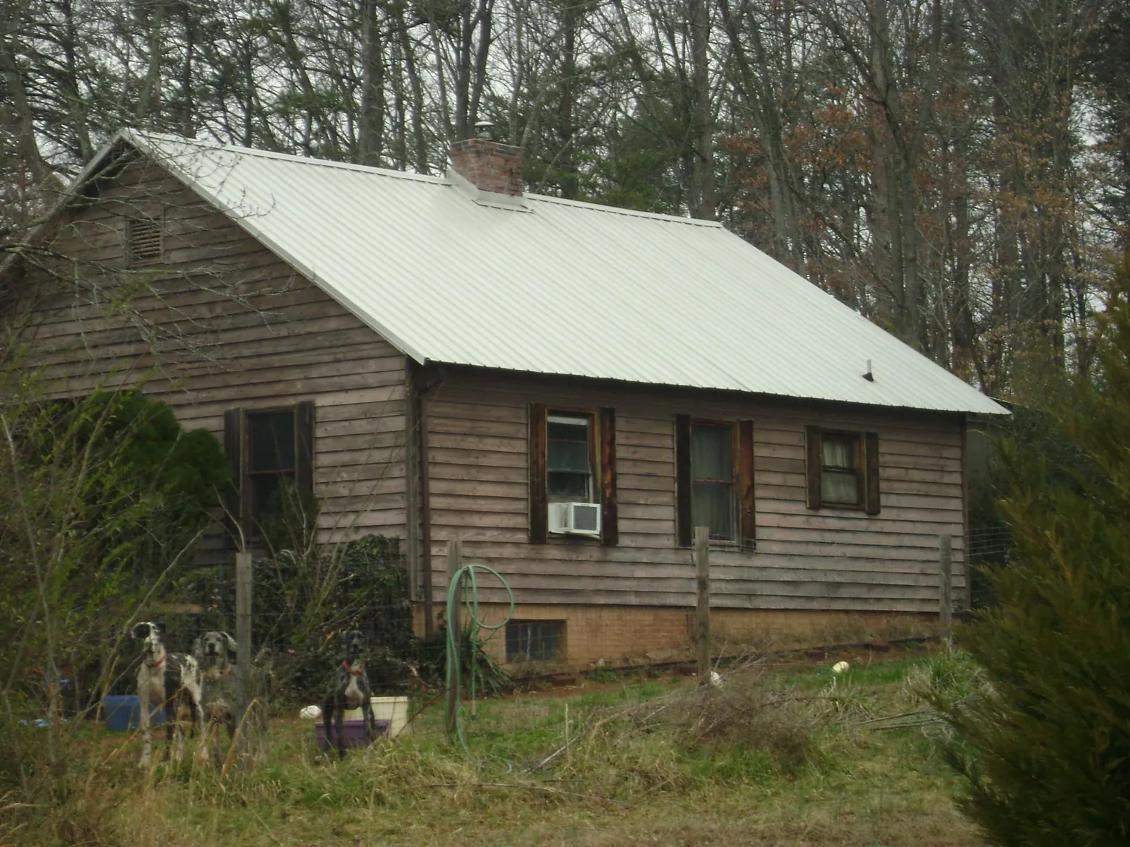 White metal roof on an old wood sided farmhouse, from a Metal Roof Installation job in Moonachie